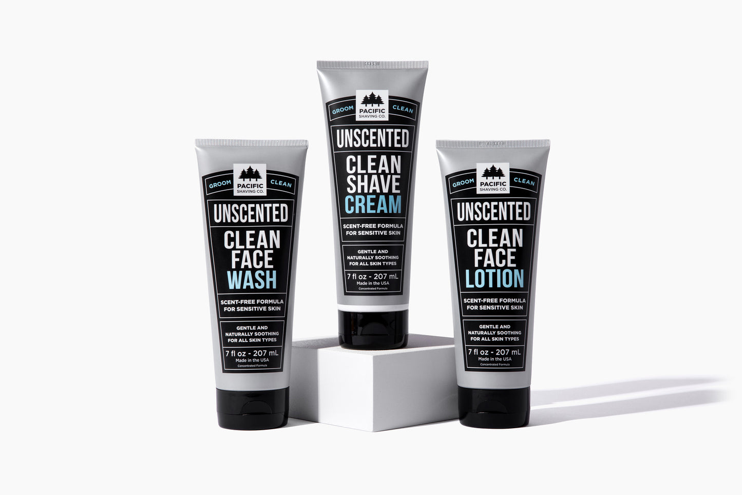 Three tubes of clean, unscented shaving products: face wash, shave cream, face lotion.