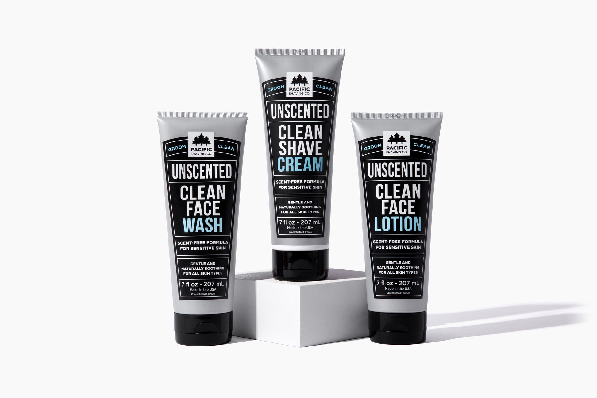 Three tubes of clean, unscented shaving products: face wash, shave cream, face lotion.