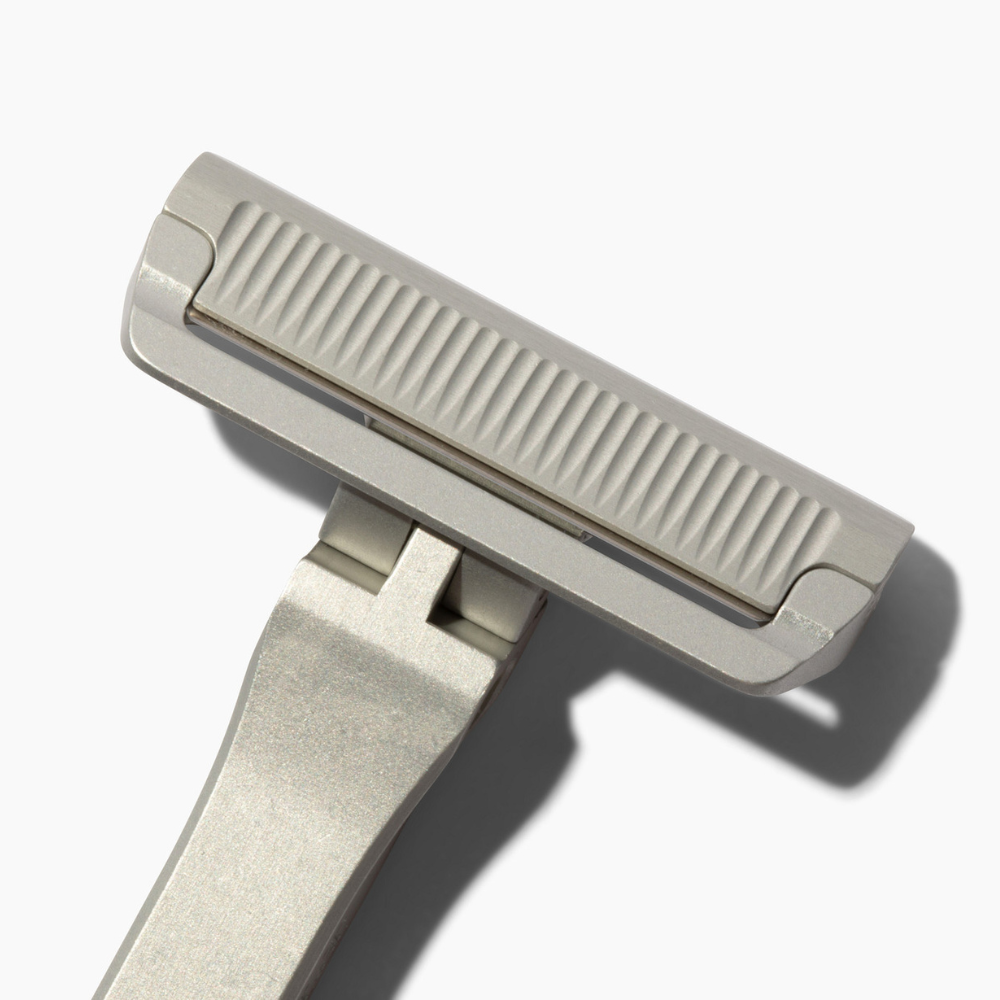 Metal safety razor on a white background