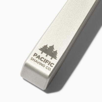 Metal safety razor with Pacific Shaving Co. branding on a white background
