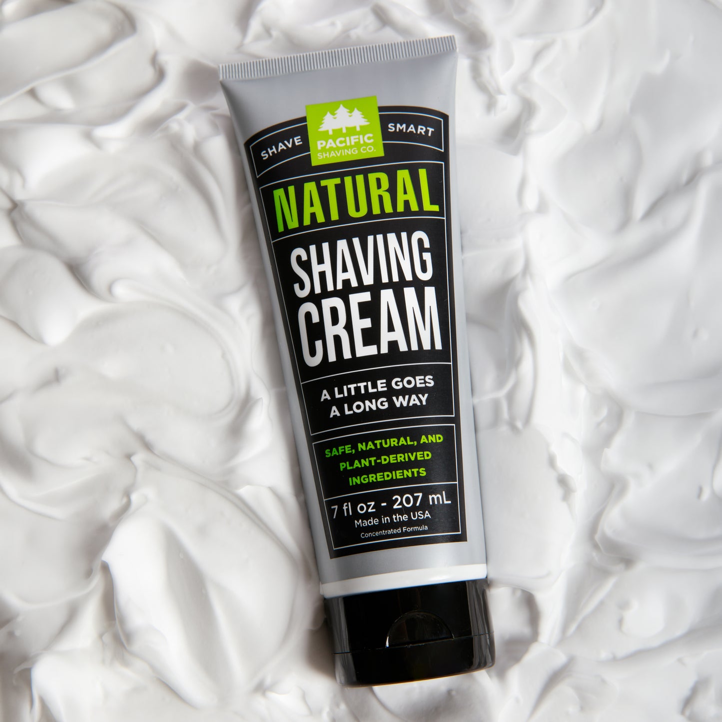 Tube of natural shaving cream on a white shaving cream background