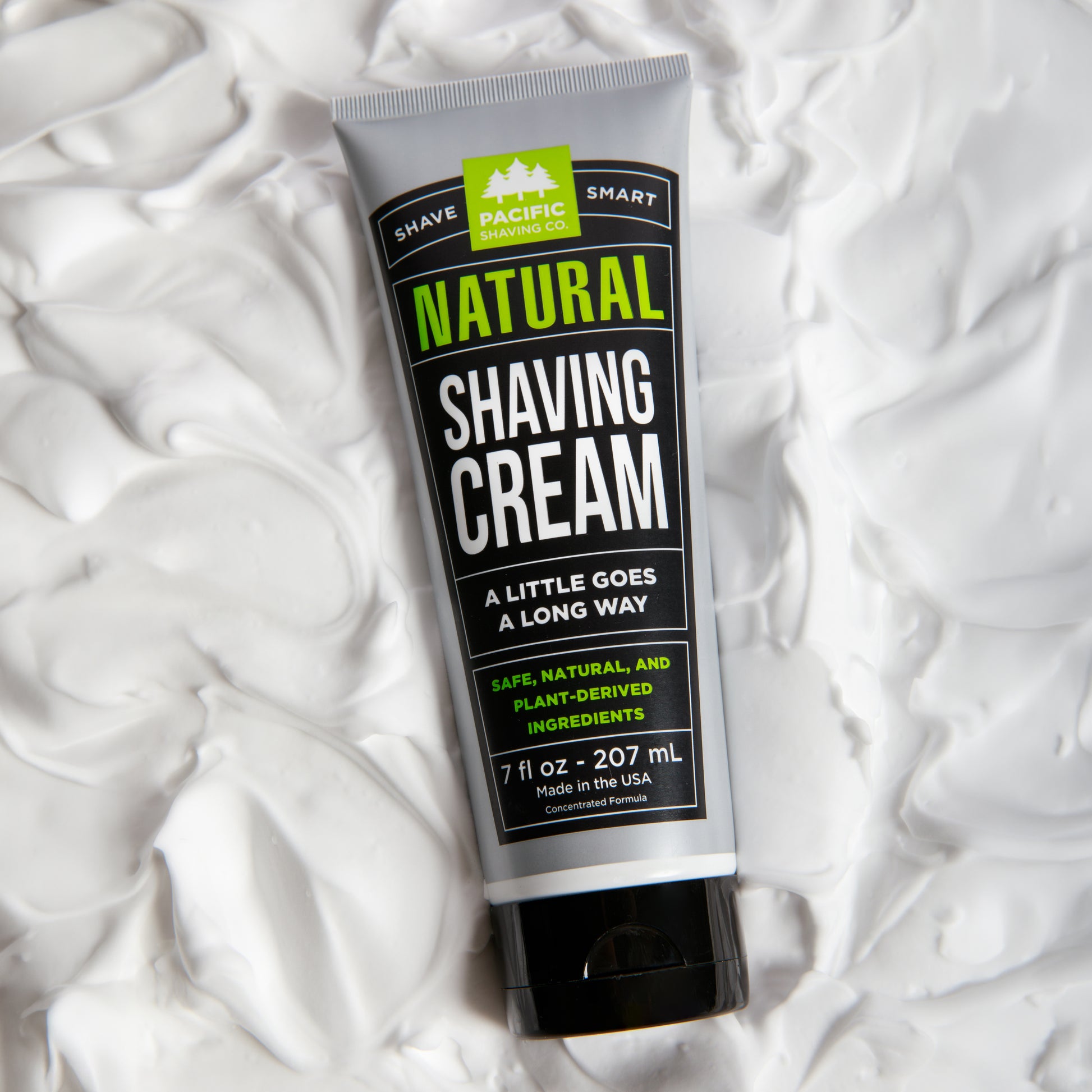 Tube of natural shaving cream on a white shaving cream background