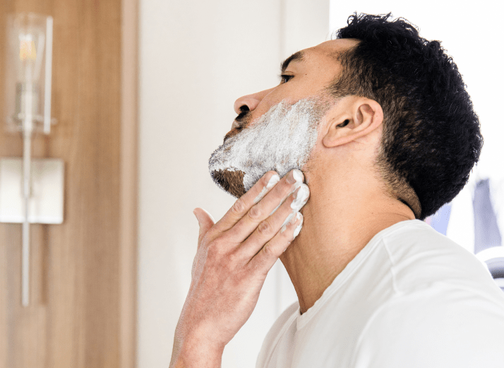 handsome man applying shave cream