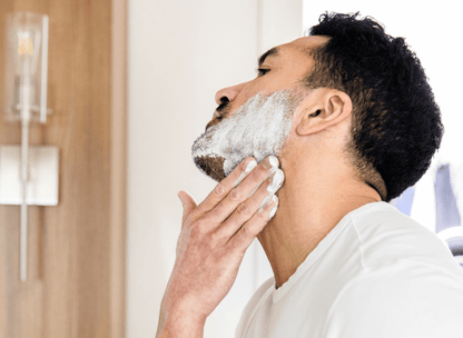 handsome man applying shave cream